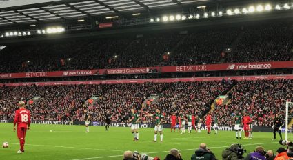Liverpool soccer players and fans in Anfield Stadium