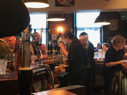 Bartender pouring a beer at a pub in Burnley, Lancashire
