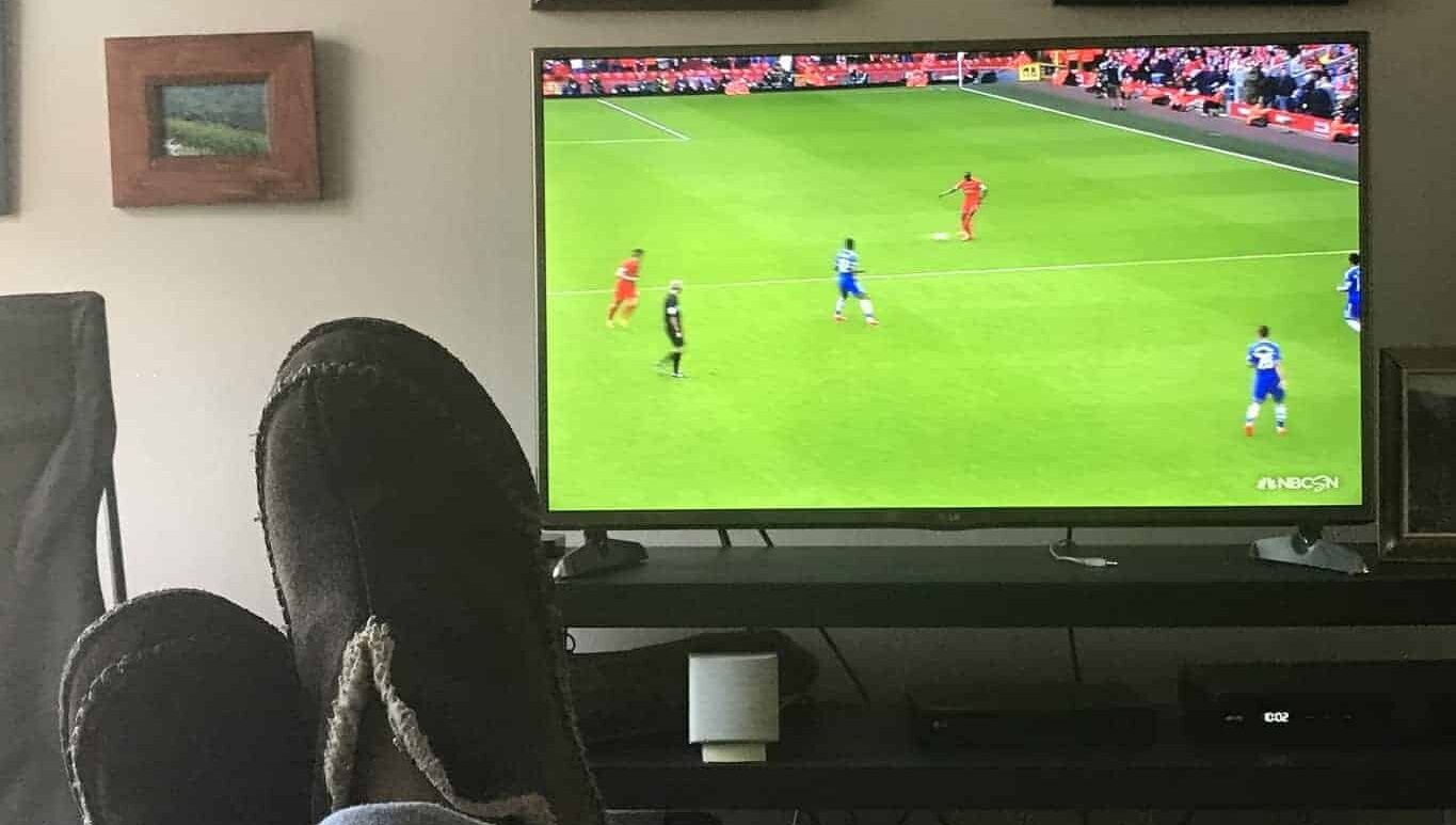 person watching soccer on tv in US at home