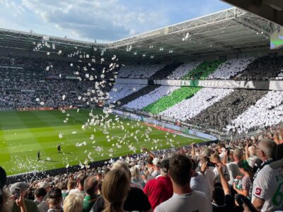 football fans showing a pregame display and throwing paper in the air