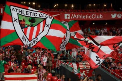 BILBAO, SPAIN - AUGUST 28: Fans of Athletic Club Bilbao move flags during a Spanish League match between Athletic Bilbao and FC Barcelona, celebrated on August 28, 2016 in Bilbao, Spain