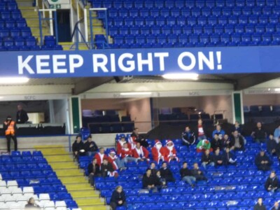 santas at an english soccer game during the holidays