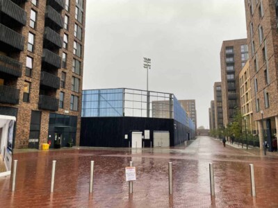 Plough Lane couldn't be more "tucked in" to its new home. exterior of plough lane stadium with housing
