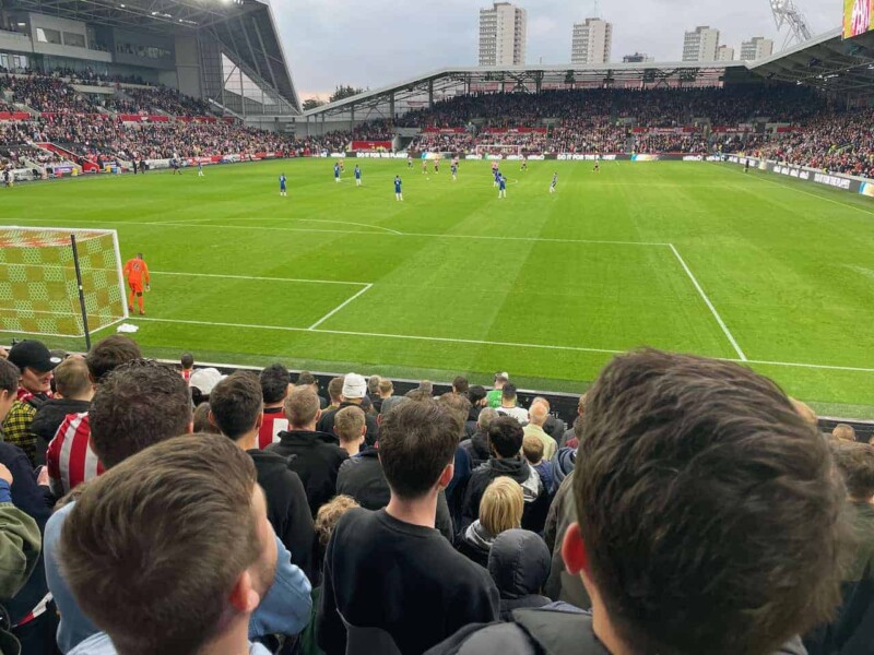 fans watching a football game at brentford community stadium.