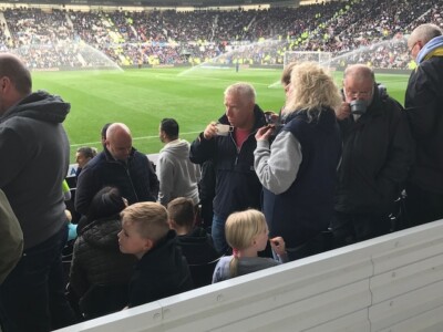 football supporters having a cup of tea inside the stadium