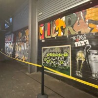 paintings on walls in a stadium concourse