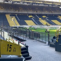 inside a football stadium with grow light son the pitch