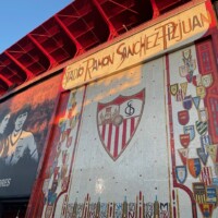 Artwork on the outside of Sevilla's stadium featuring the club crest