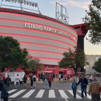 Fans walking up to a football stadium