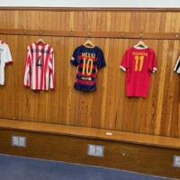 In the away locker room -- I believe with shirts of players who played there? Just behind a wall is the street, and supporters know exactly where it is!