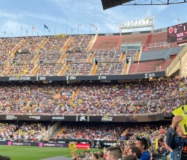 Sending a message to the club's unpopular owner. a fan holding up a sign reading "Lim go home" at Valencia