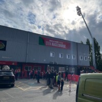 An eager group of fans waiting for the players prior to kickoff.